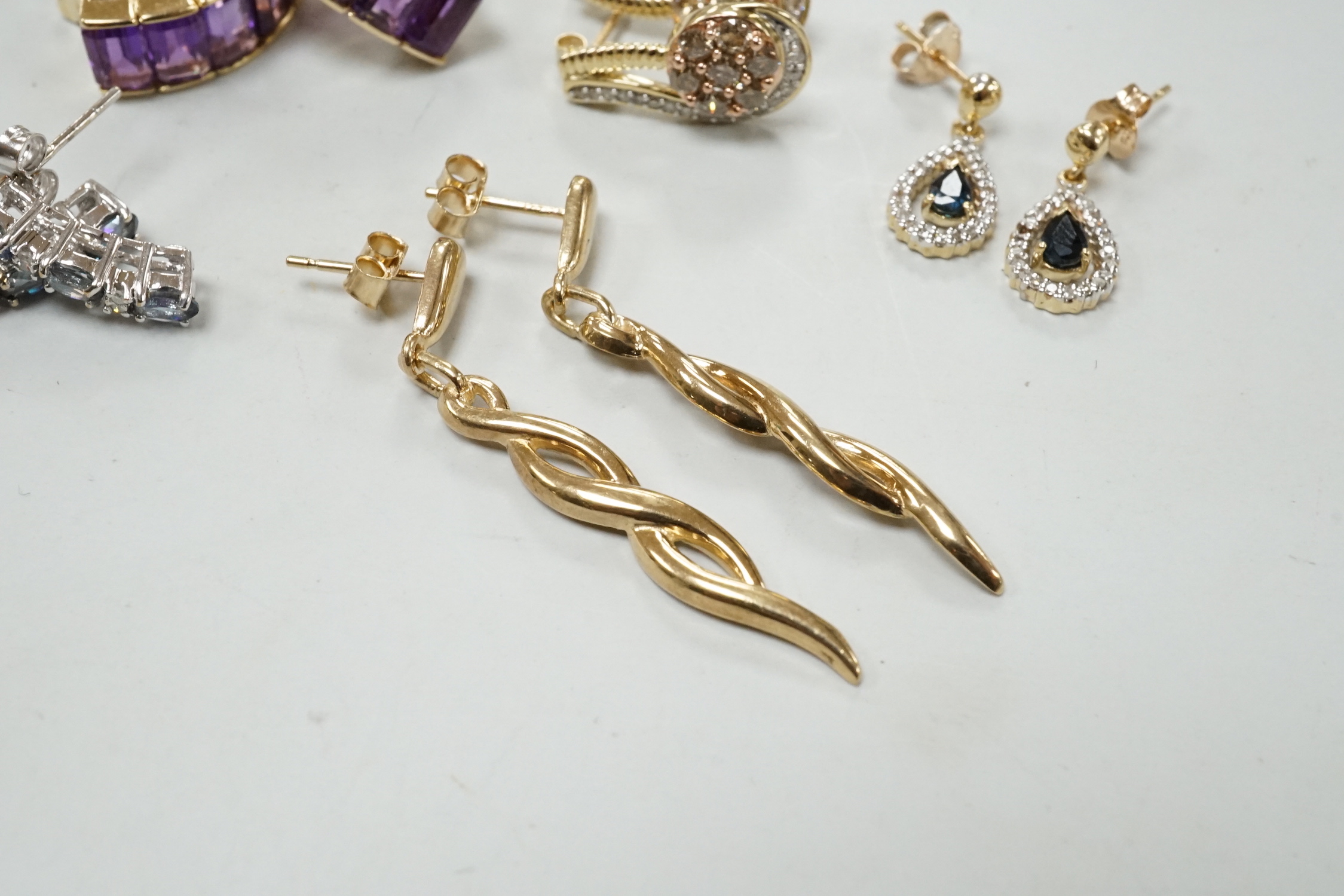 A modern pair of 585 yellow metal and five stone amethyst set demi lune earrings, 18mm, gross weight 6.2 grams, together with three modern pairs of 9ct and gem set earrings including two colour diamond cluster and one ot